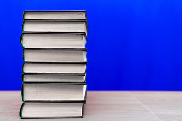 stack of old books, grungy background, free copy space blue background