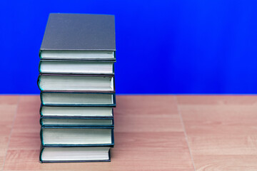 stack of old books, grungy background, free copy space blue background