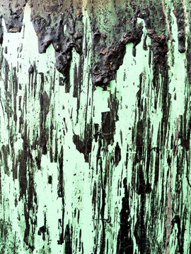 Close up of dripping viscous liquid on metal trash container