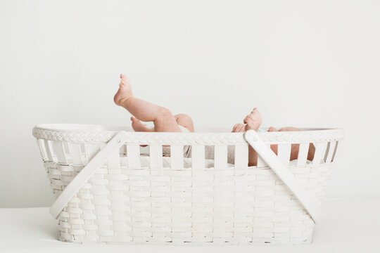 flailing baby in a basket