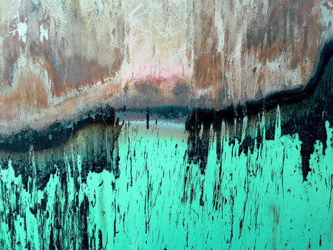 Close up of dripping toxic sludge on rusty, metal trash canister