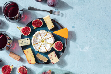 Cheese banner. A variety of cheeses on a plate, shot from the top with a place for text, a flat lay