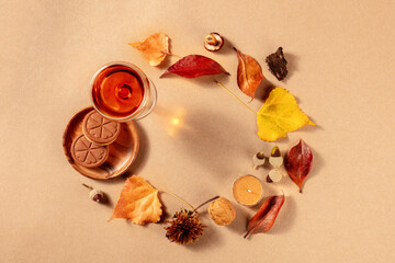 Autumn wreath with fall leaves, sweet wine, and cookies, a flat lay with a place for text, shot from above