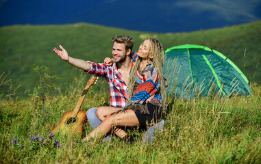 Cute couple. western camping. hiking. couple in love spend free time together. country music. romantic date. friendship. campfire songs. men play guitar for girl. happy friends with guitar