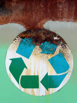 Close up of recycling symbol on industrial trash can