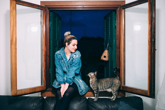 woman and cat looking each other