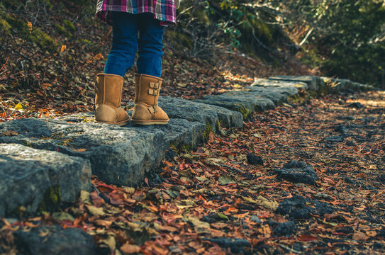 Child Walking On Stone Path In Autumn