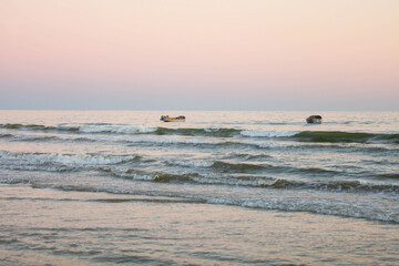 Naklejka premium Boats in the evening sea
