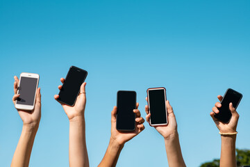 Group of hands showing smartphone with copy space