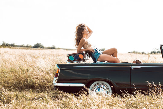 Young Woman Posing in Cabriolet Car