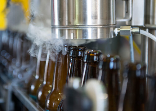 Beer bottles at a brewery are treated with carbon dioxide prior to filling