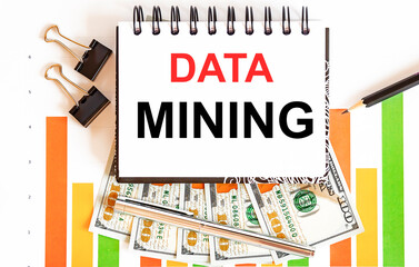 Inscription DATA MINING in notebook, concept of planning, with office tools ,chart and dollars