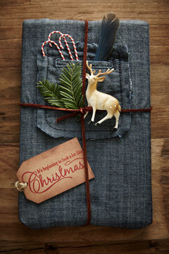 Hipster gift wrapped in denim with leather twine and ornaments