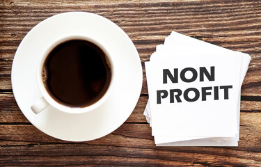 Word writing text NON PROFIT . Business concept for Urgent Move.Text in stickers with a cap of coffee