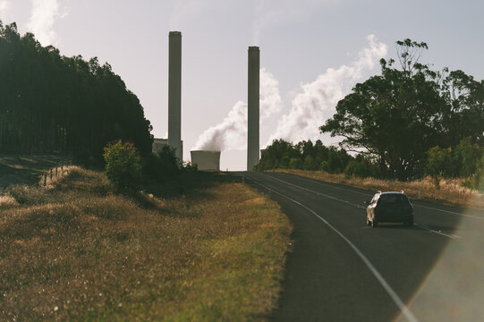 Car Driving up Hill towards Power Plant