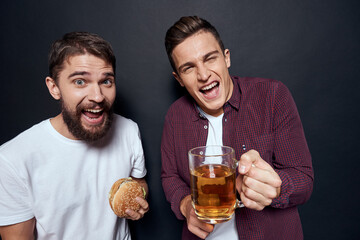 Two drunk friends drinking beer rest fun dark background