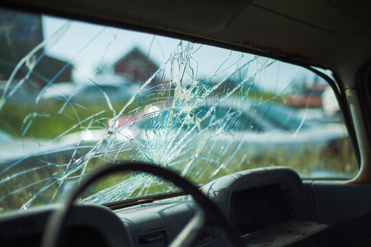 A broken windshield of a car.