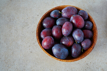 fresh plums on granite surface