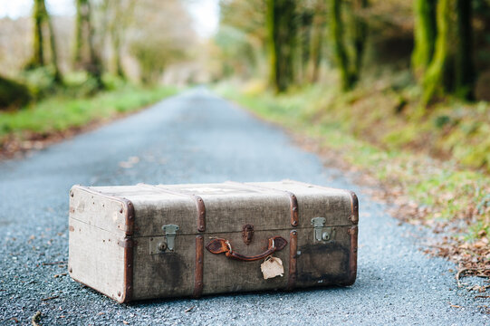 Vintage Suitcase On A Country Road In Autumn