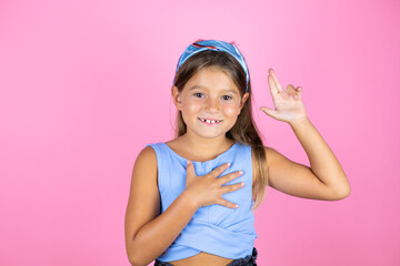 Young beautiful child girl over isolated pink background smiling swearing with hand on chest and...