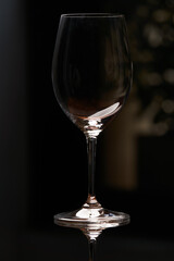 Empty wine glass on a dark background with copy space
