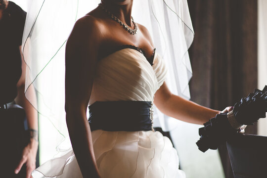 A Bride waits in her gown.