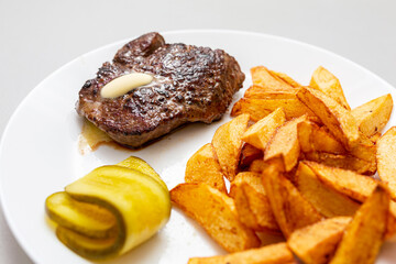 Grilled beef steak with french fries on the plate