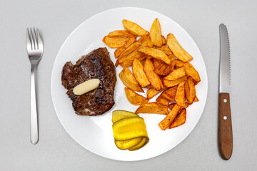 Grilled beef steak with french fries on the plate