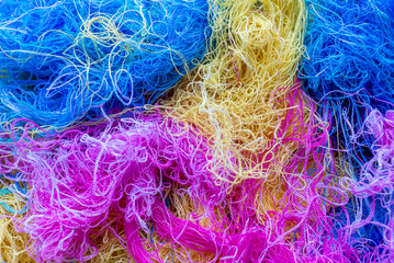 Multi-colored tangled threads abstract texture pattern background. Macro shot of colorful needlecraft silk thread ropes.