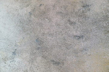 Texture of a light gray wall with scuffs. Rough surface background. Old wall