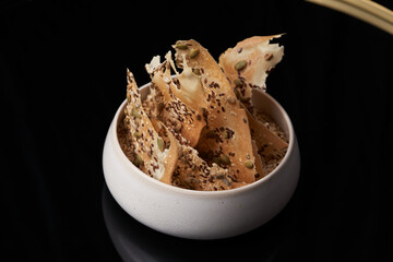 Whole grain cereal chips. Crispy crackers with sesame