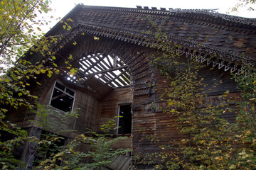 The ruins of an abandoned house.
Ruins of an old wooden abandoned house. The roof and walls of an abandoned wooden house.