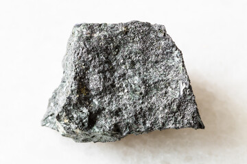 closeup of sample of natural mineral from geological collection - rough Magnetite ore on white...