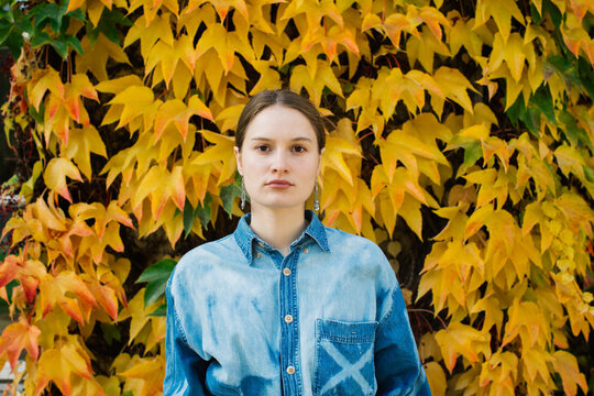 Fall - Young Caucasian Woman Standing in Front of Yellow Ivy Lea