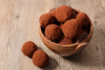 chocolate truffle with cocoa on wood background