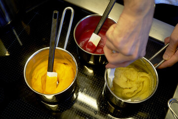 Cooking sauce on electric stove. Variety of sauces, tomato, pumpkin