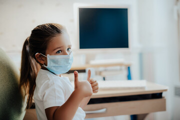Distance learning online education. Quarantine training. white child little girl studies at home,...