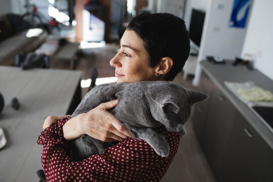 Portrait of smiling woman holding her kitty