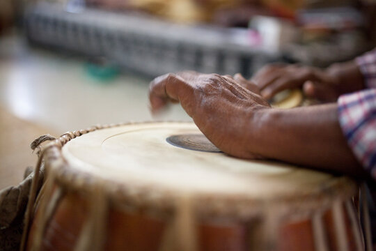 Man playing on traditional Indian tabla drums close up
