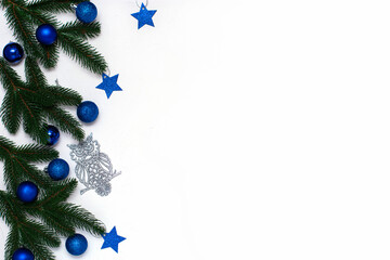 Christmas flatlay with fir branches, blue and silver  decorations on white background. Christmas composition, top view, copy space. New Year background.