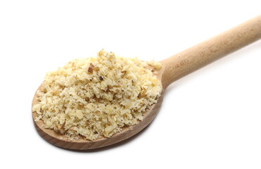 Milled walnuts pile in wooden spoon isolated on white background