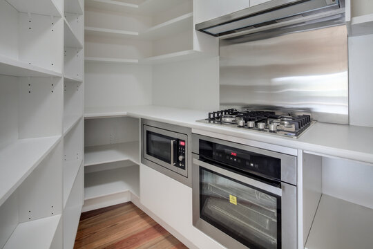 Small compact kitchen and pantry, empty