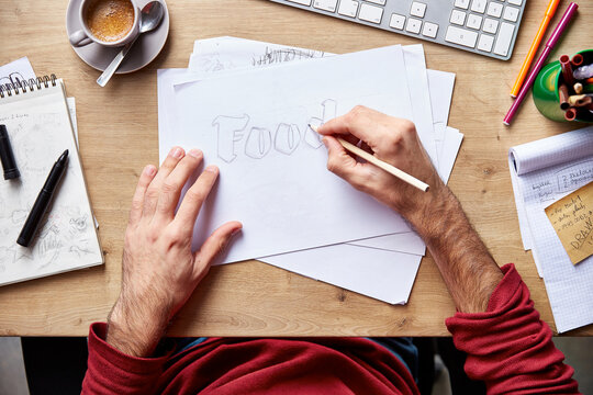 Man drawing food word on paper.