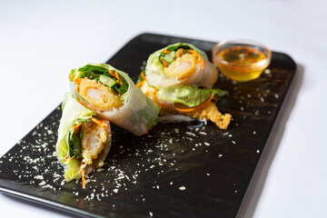 Saigon sushi roll served on a black stone