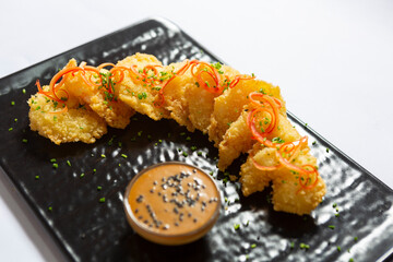 Japanese style deep fried shrimp served on a black stone