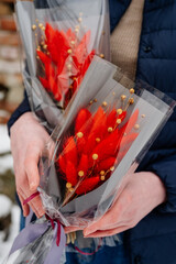 Two small bouquet of red dried plants in package