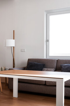 Grey sofa near window