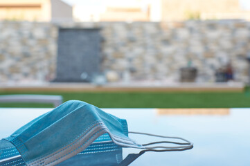 Selective focus of medical mask on table outdoor