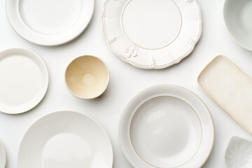 Top view of empty plates on white background