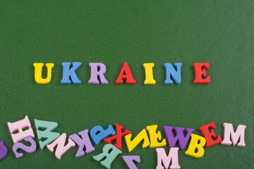 UKRAINIAN word on green background composed from colorful abc alphabet block wooden letters, copy space for ad text. Learning english concept.